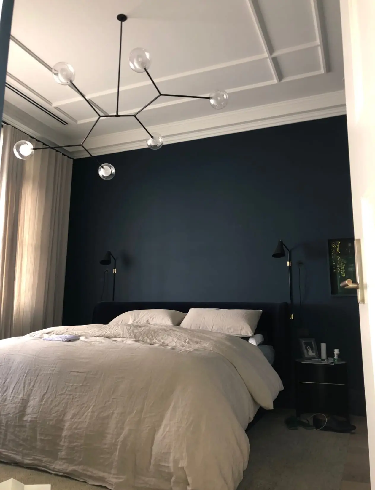 Bedroom finished in deep navy with a white panelled ceiling and cornice
