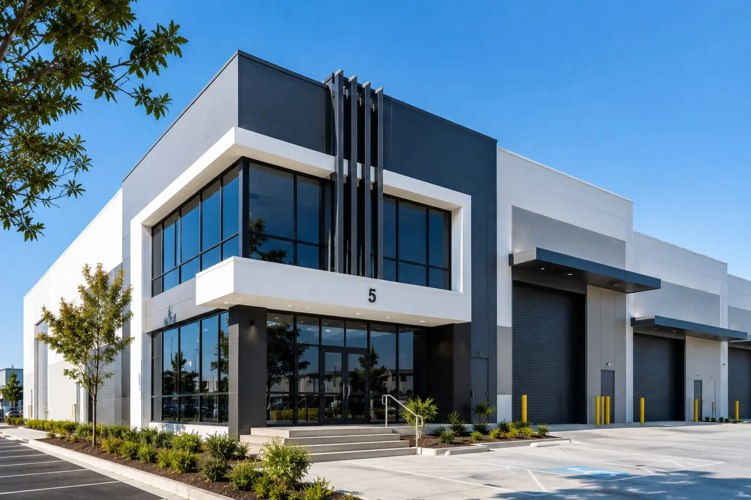 Modern white and charcoal commercial building exterior with glazed corner entry