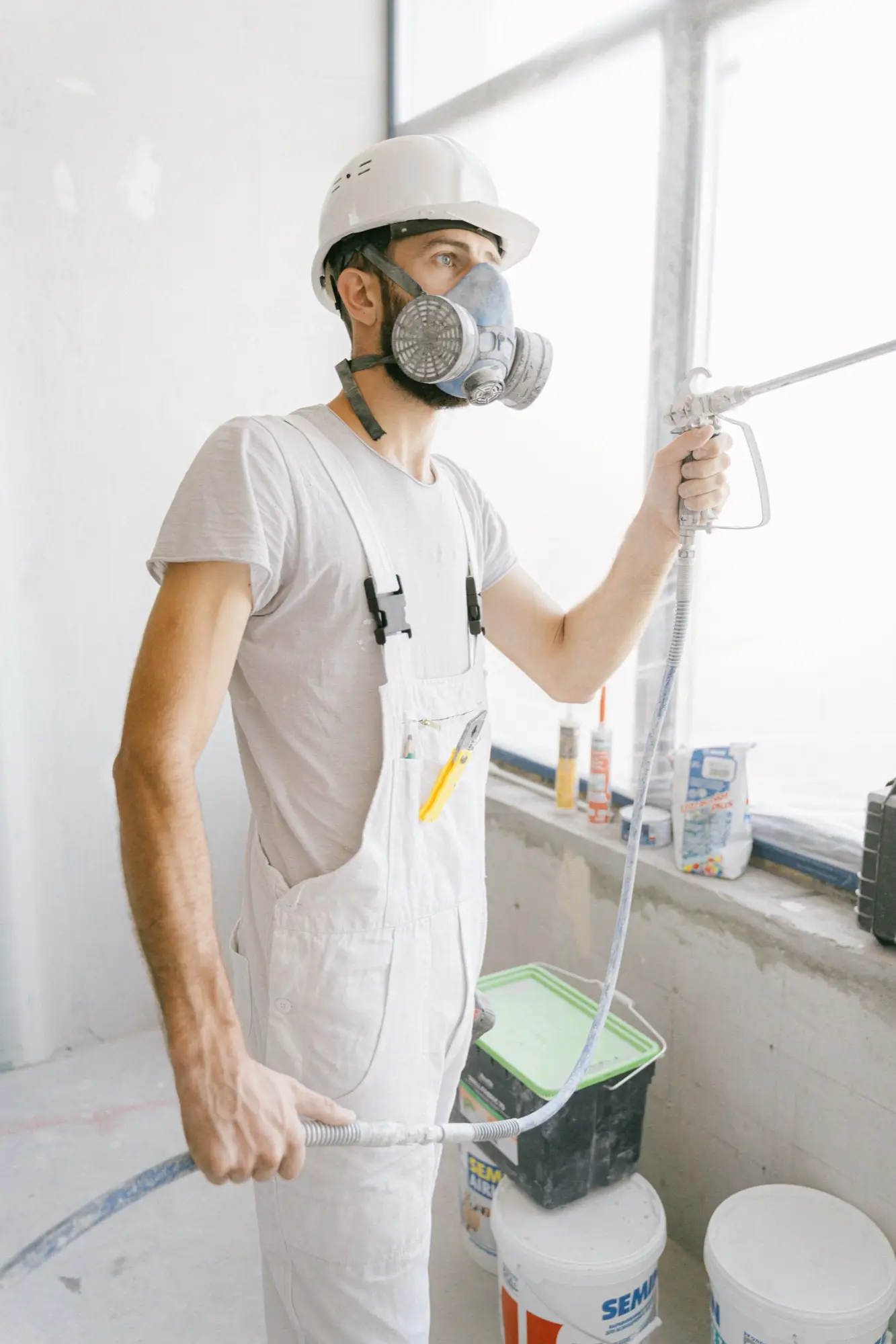Painter cutting a clean line along a wall edge with a brush