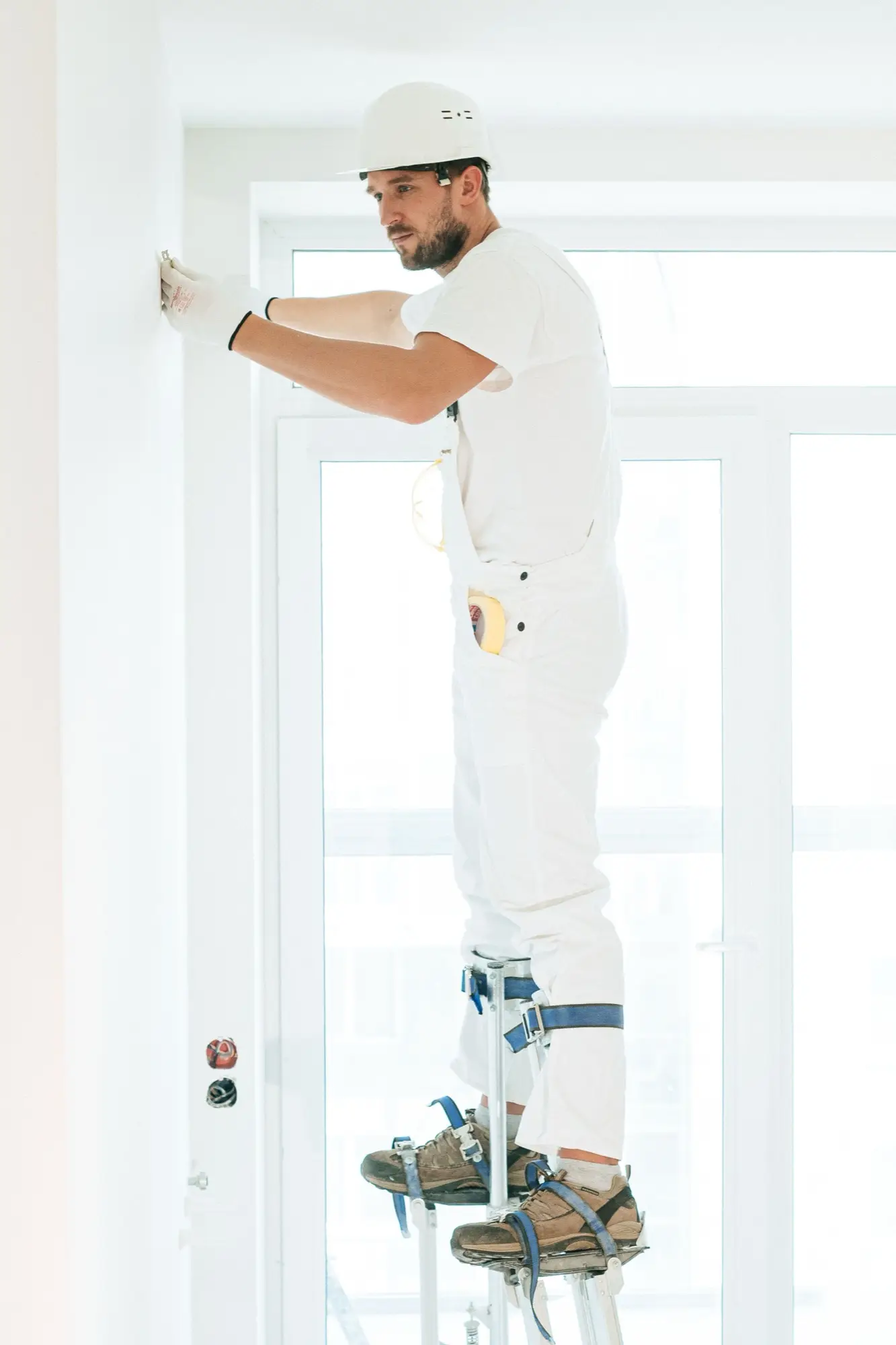 Painter working at height on a large interior
